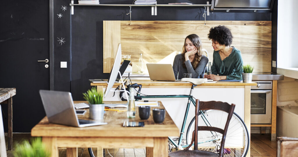 Two workers using laptop in modern office Mobi - Getty (Photo by Westend61) 0